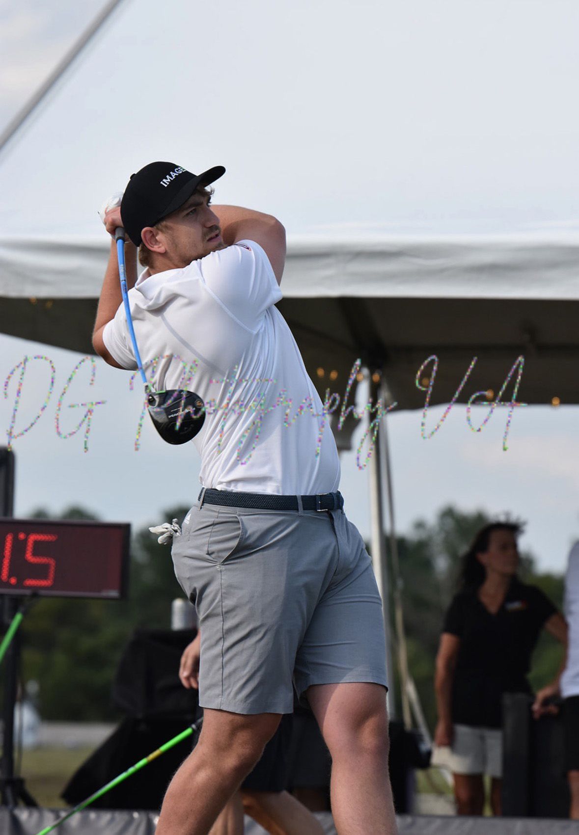 Three golf clubs and a golf ball are on the grass.
