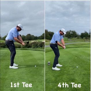 A man is swinging a golf club on a golf course.