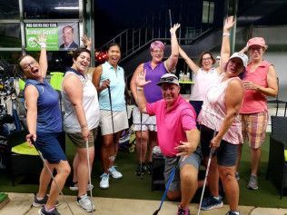 A group of people are posing for a picture while holding golf clubs.