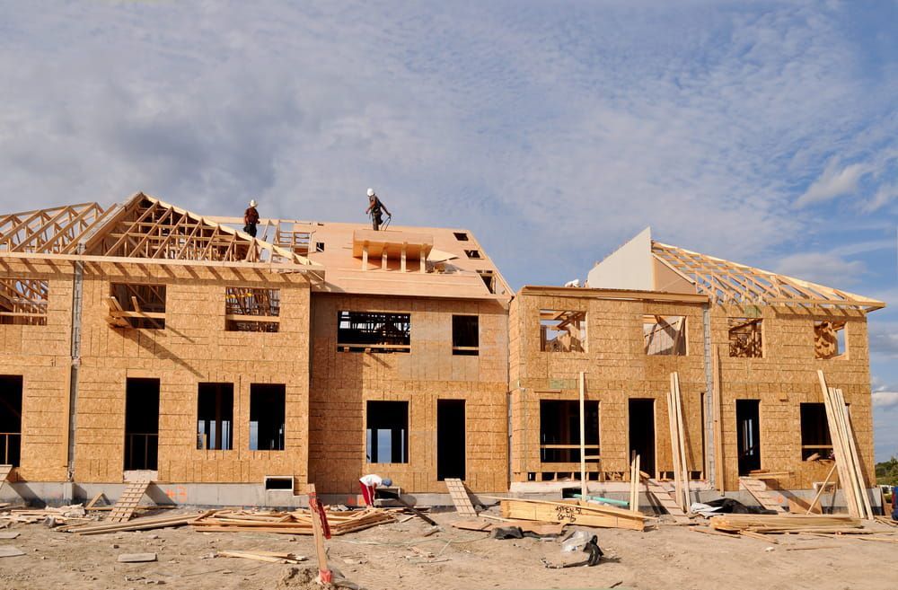 Townhouses Under Construction and Workers on the Roofs — AD Plumbing & Maintenance in Nicholls, ACT
