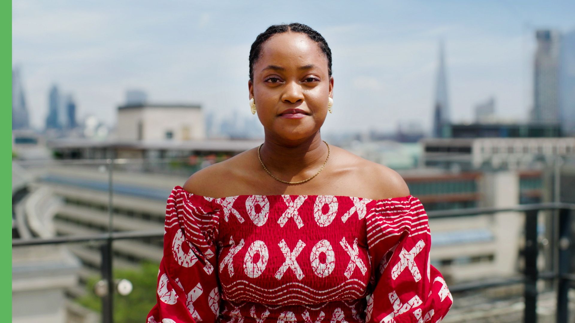 A woman in a pink tank top is smiling on a yellow background.