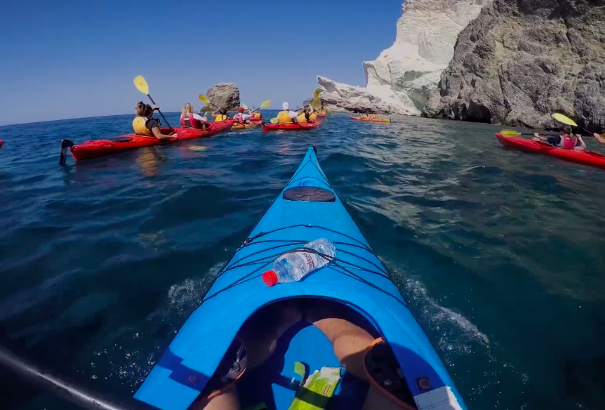 A group of people are kayaking in the ocean.