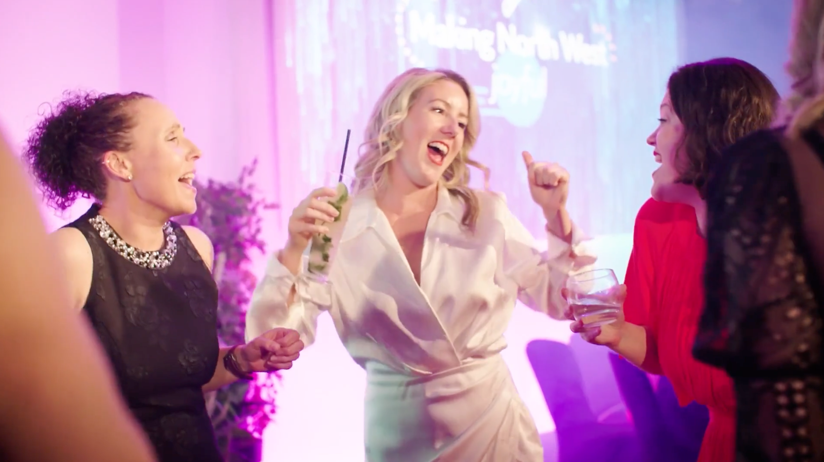 A group of women are dancing together at a party.