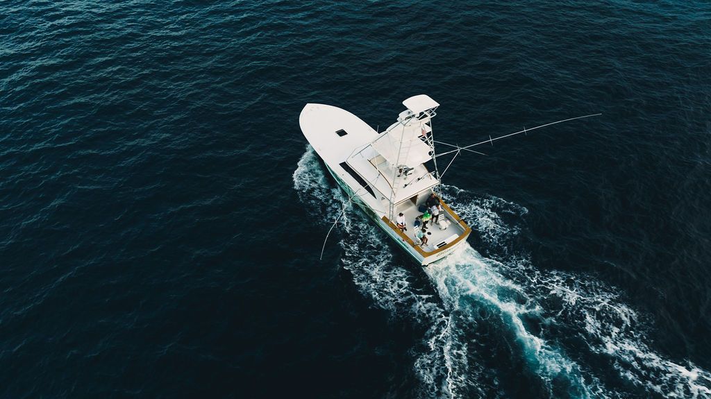 An aerial view of a boat floating on top of a body of water.
