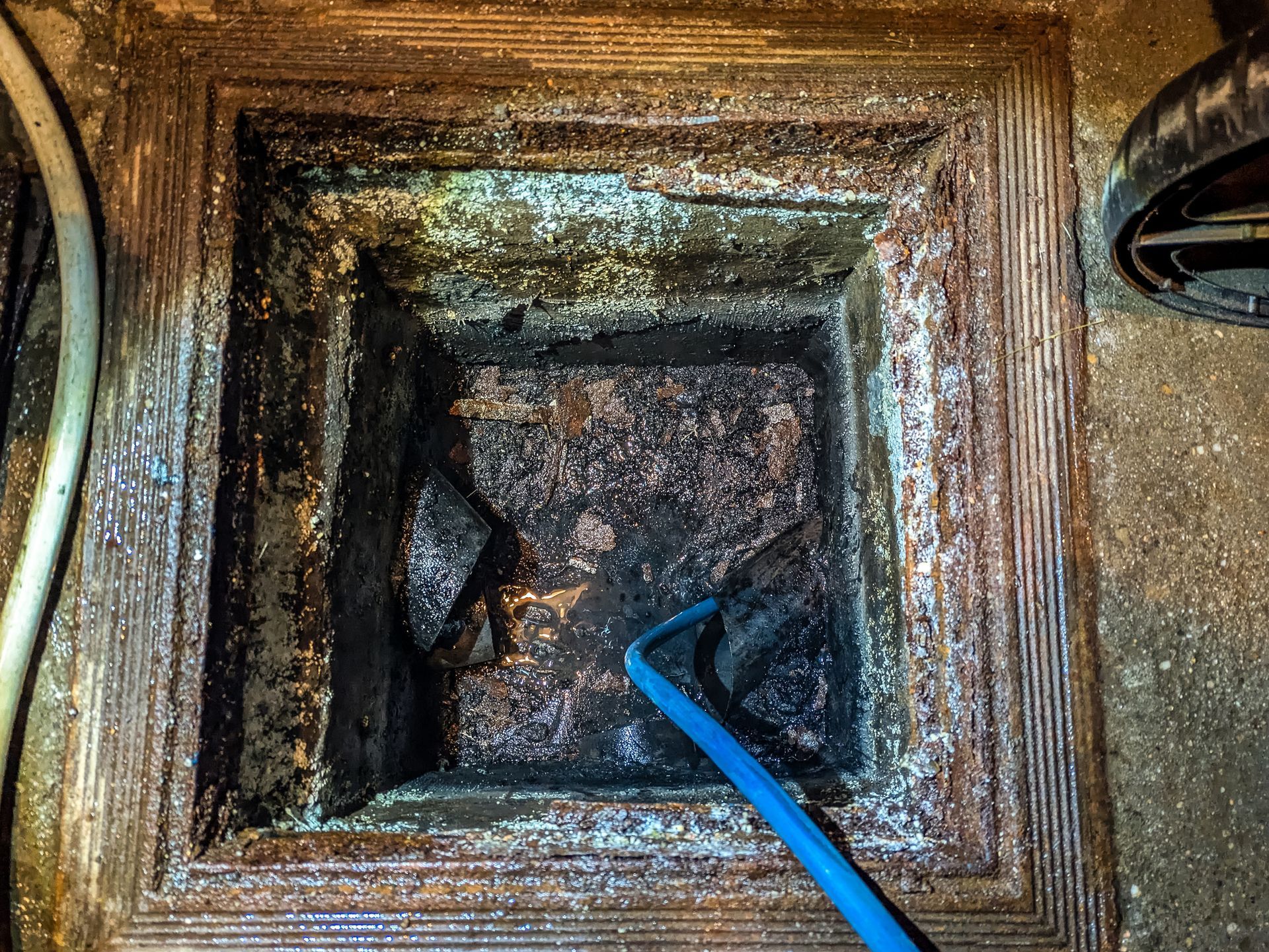 Clearing stubborn blockage from a residential sewer pipe.