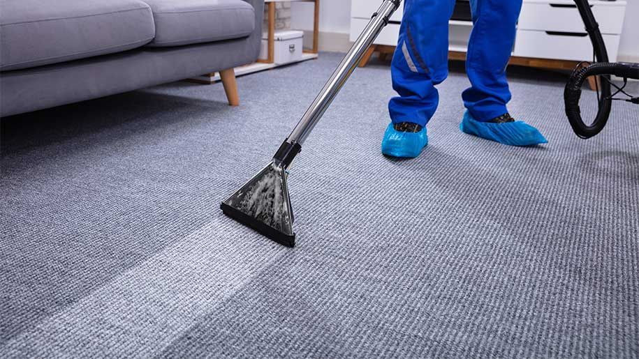 man cleaning rug