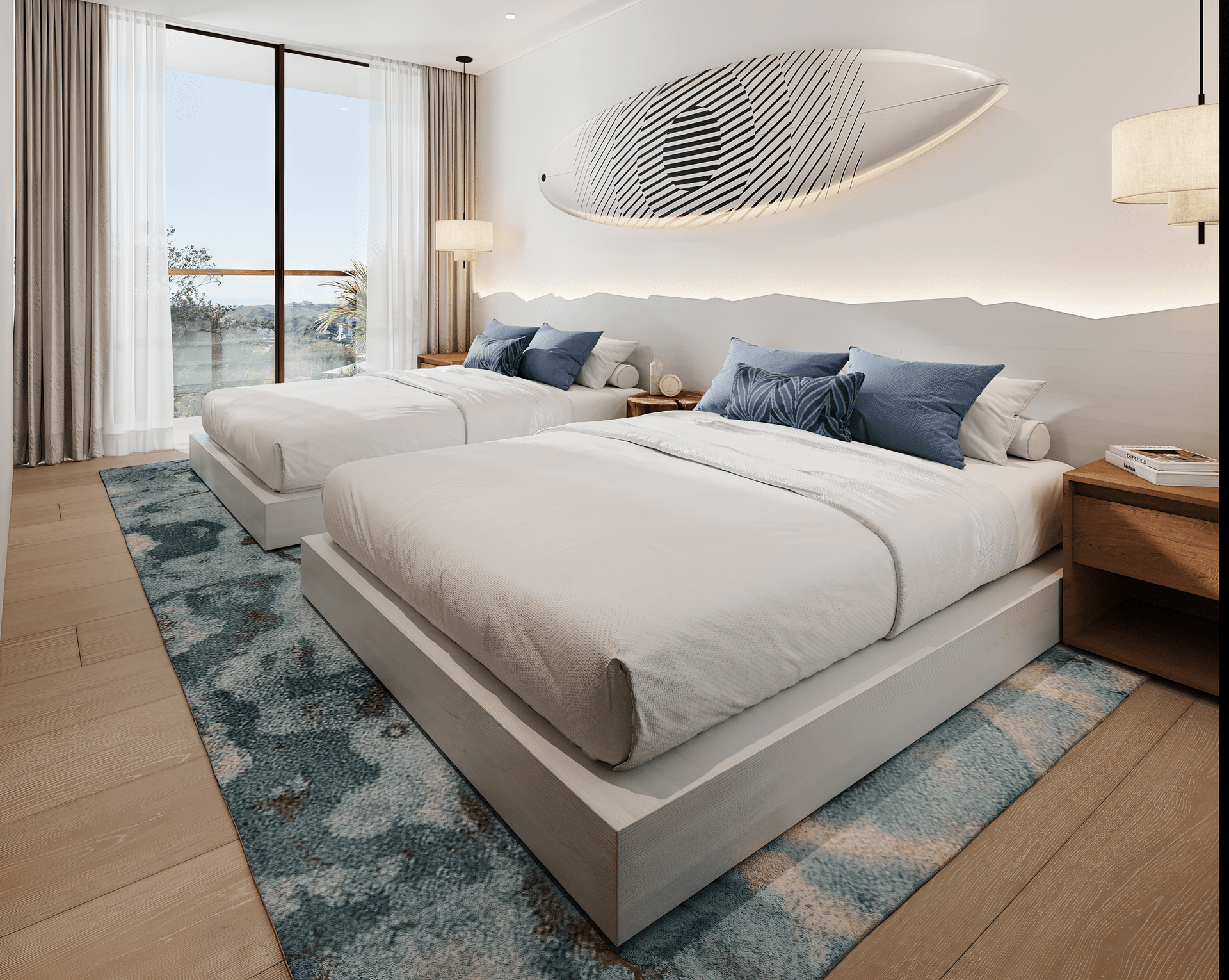 Two beds in a bright bedroom with a surfboard art piece and ocean view.