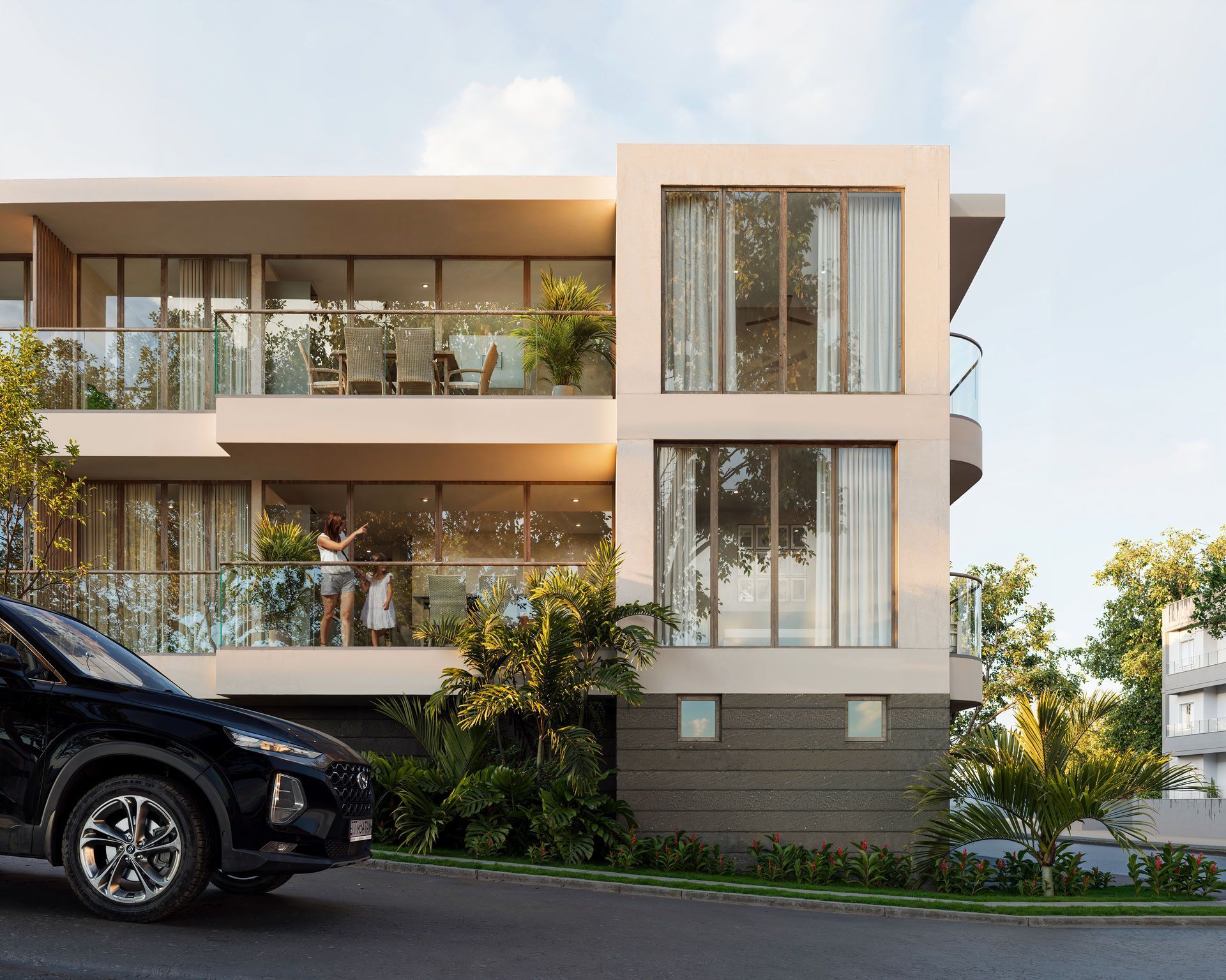 Modern building with balconies; person on balcony, black car on street.