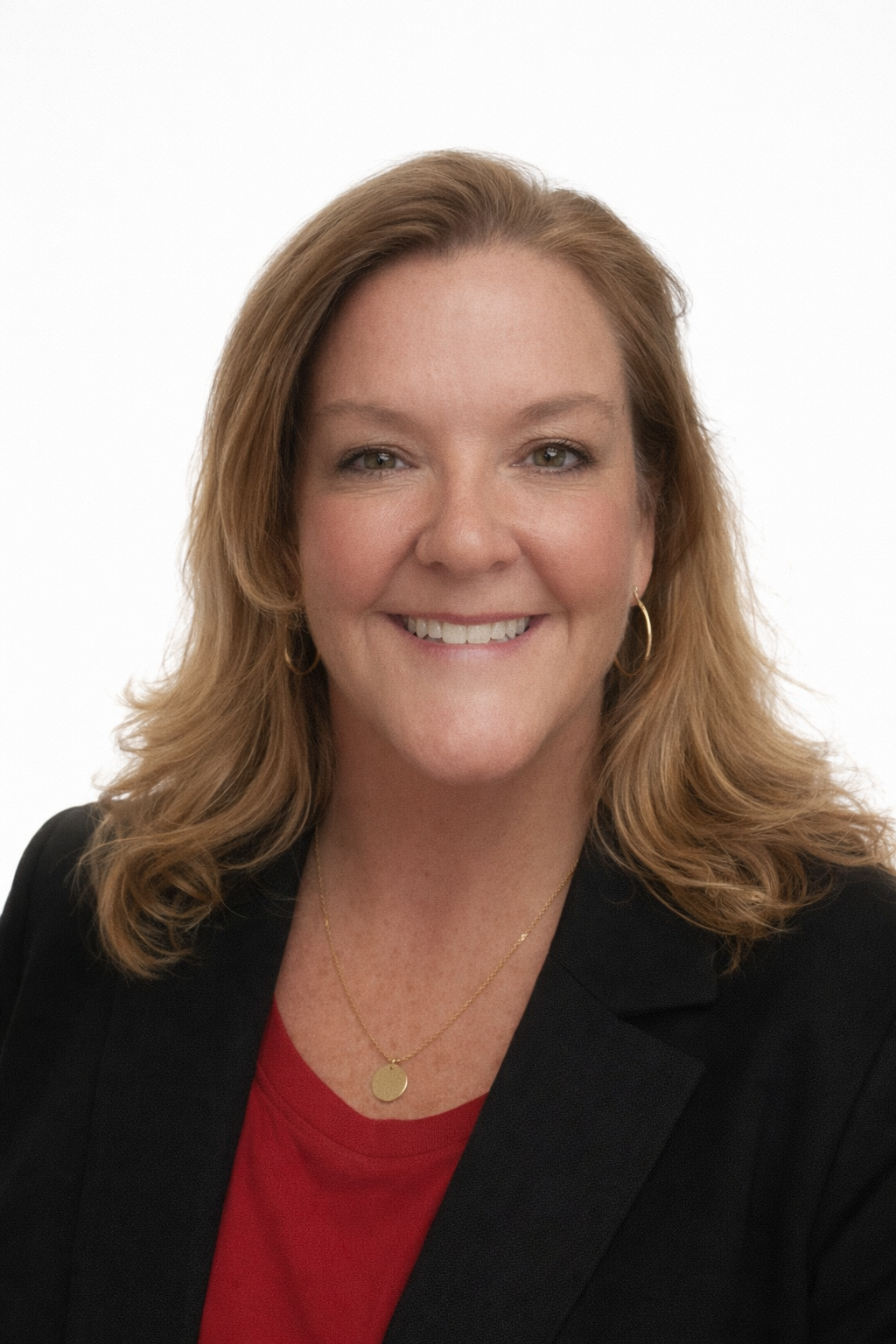 Man with graying hair and beard wearing black polo shirt with green logo.