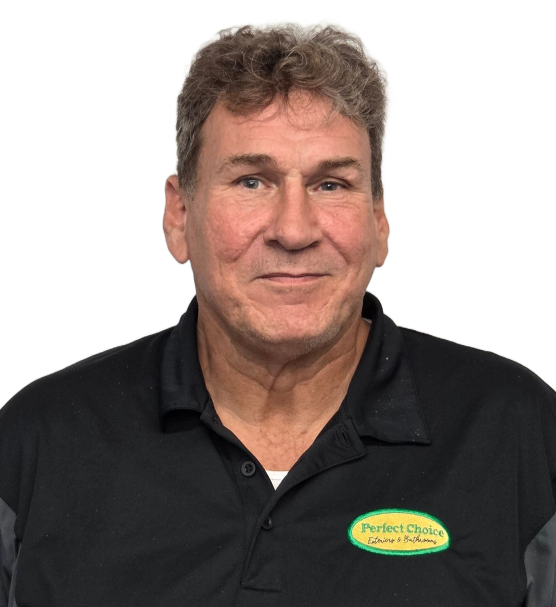 Man with curly dark hair wearing a black polo shirt smiling at camera against a white background