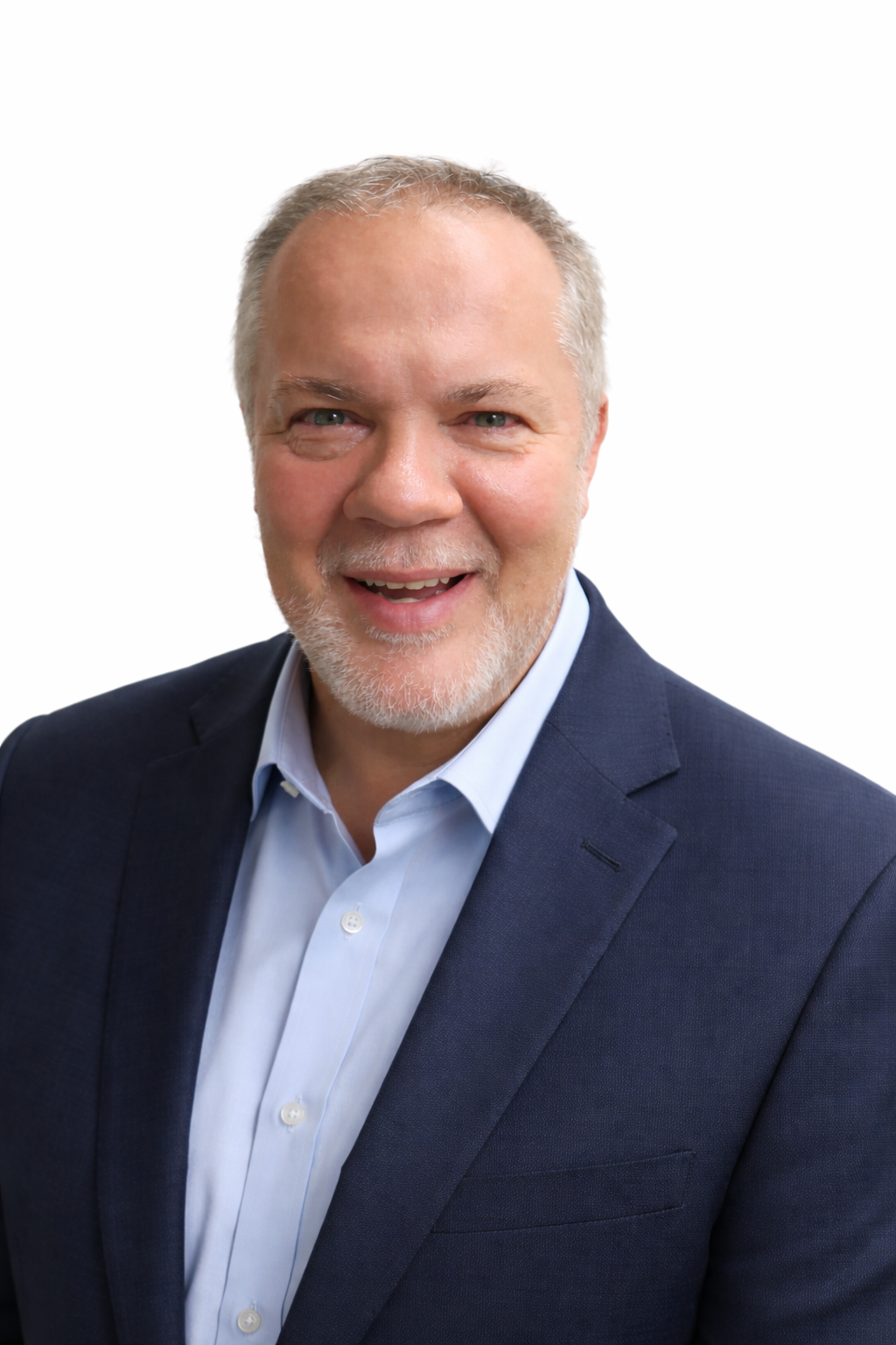 Man with graying hair and beard wearing black polo shirt with green logo.