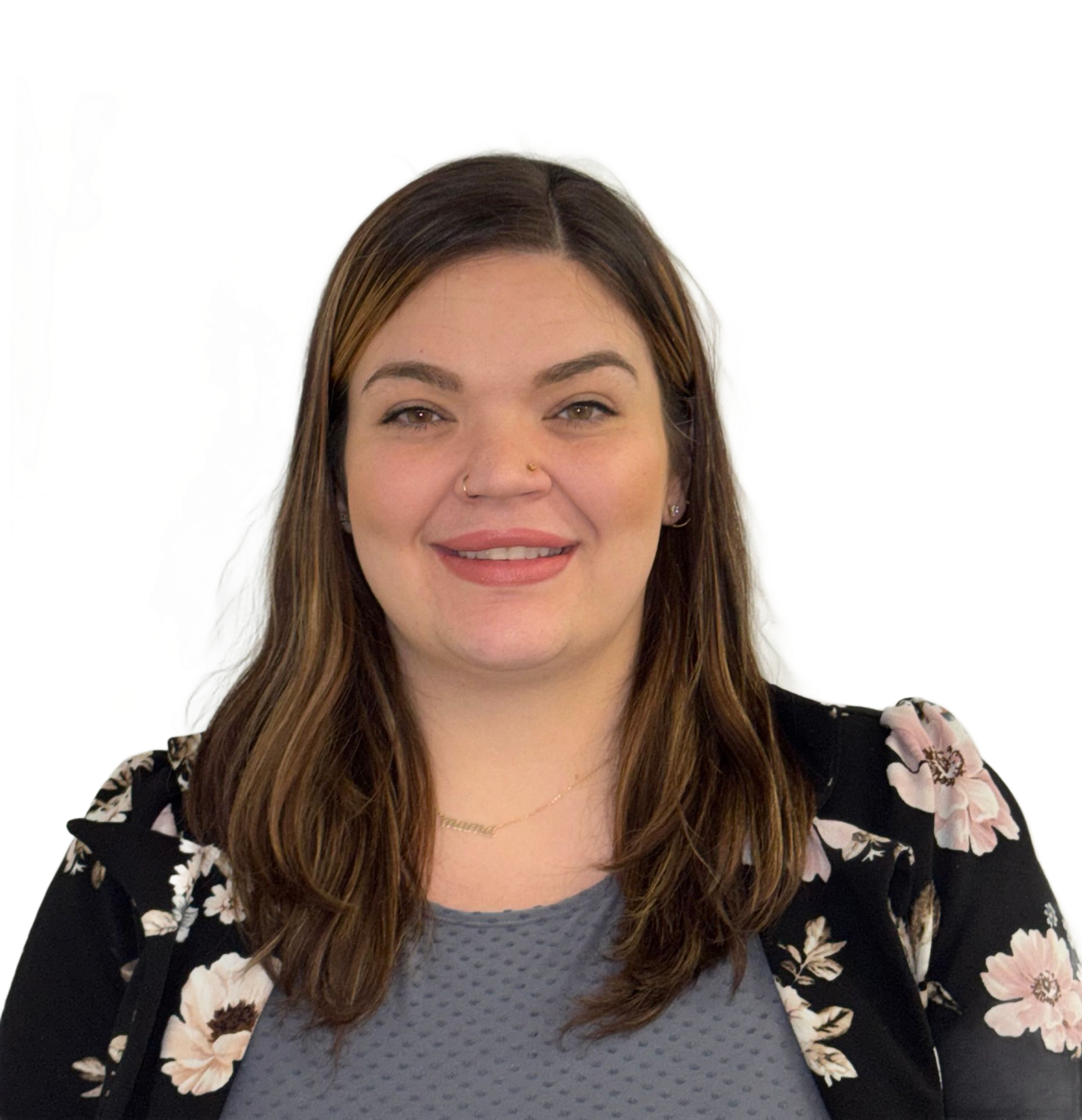 Woman smiling in a black floral top against a white backdrop.