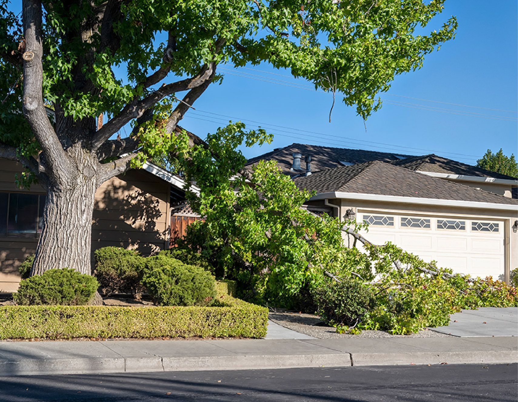 Blue bathroom vanity with gold fixtures, white countertop, and a doorway leading to a window.