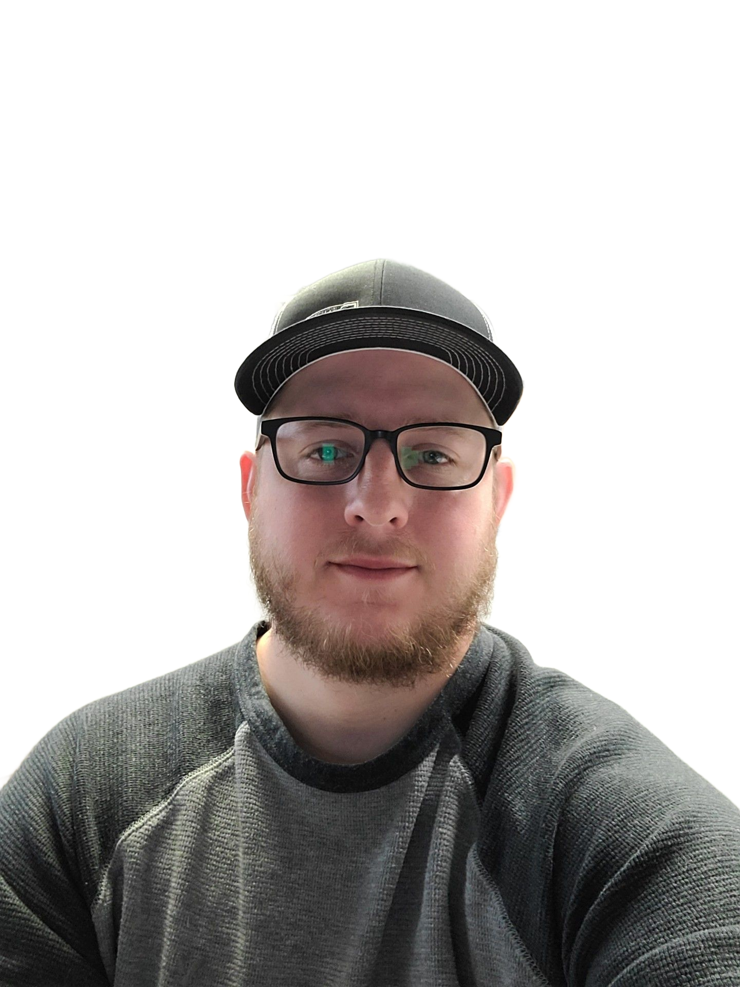 Man in a hat and glasses wearing a gray longsleeve shirt against a white background.