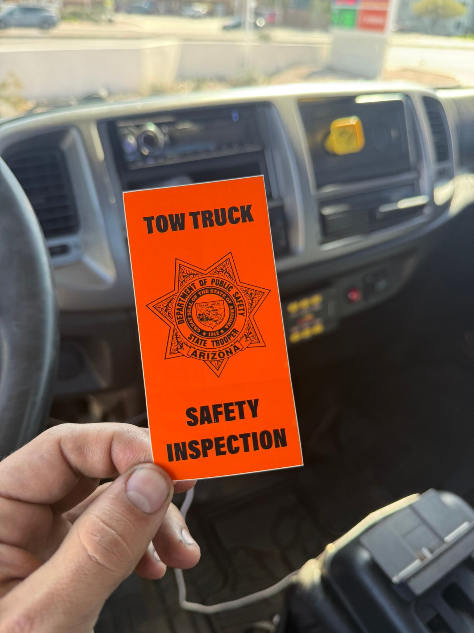 A hand holds an orange 