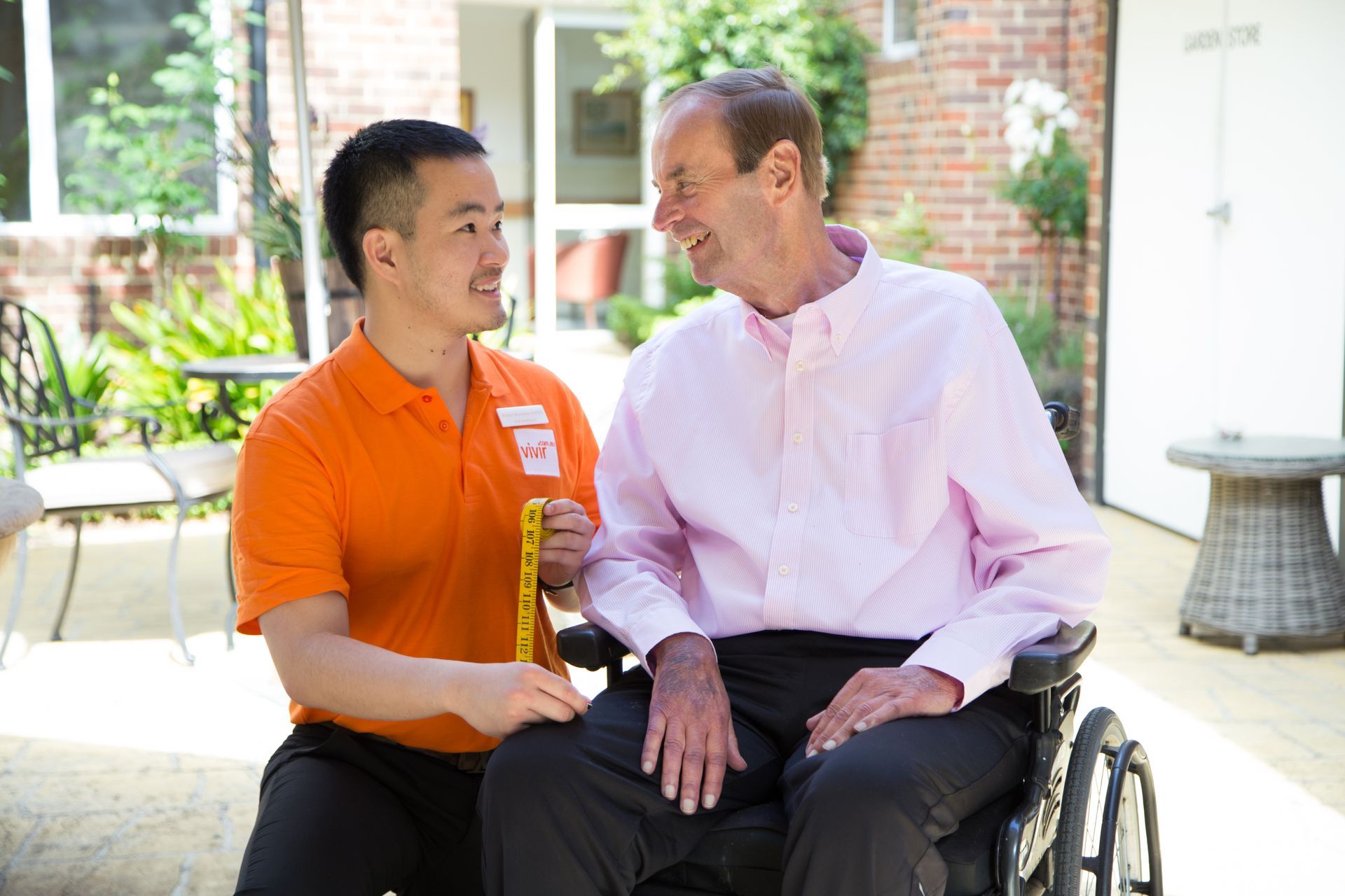 Vivir Healthcare Occupational Therapist supporting an elderly man in a wheelchair