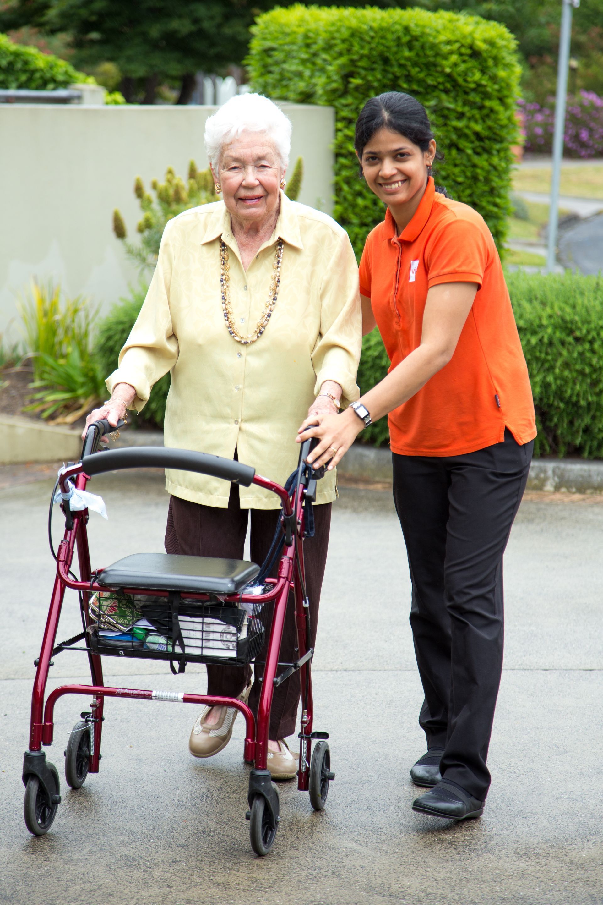 Vivir Healthcare Physiotherapist with her elderly client who uses a mobility aid.