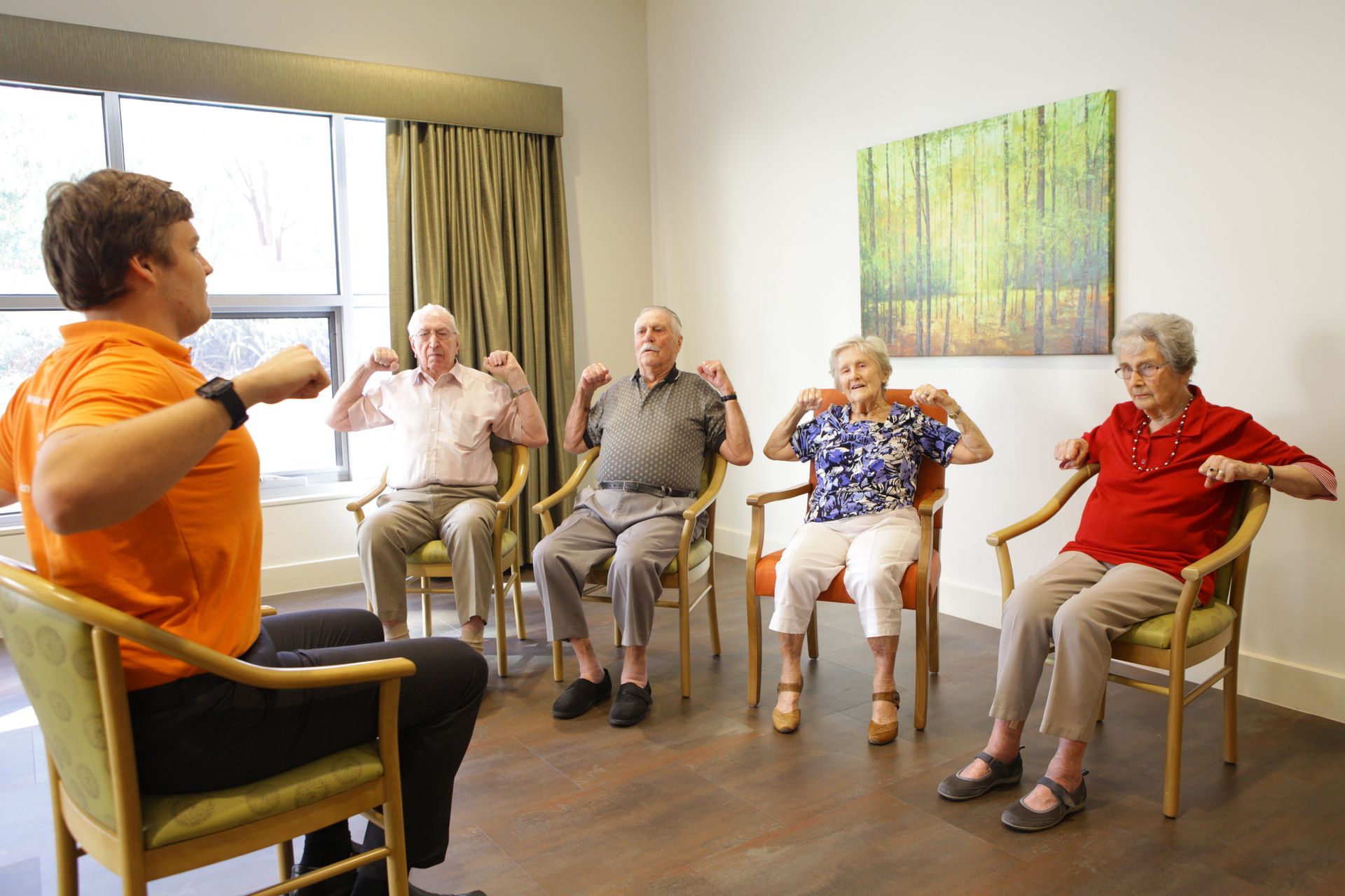 Vivir Healthcare Physiotherapist leading a group therapy session in a residential aged care facility.