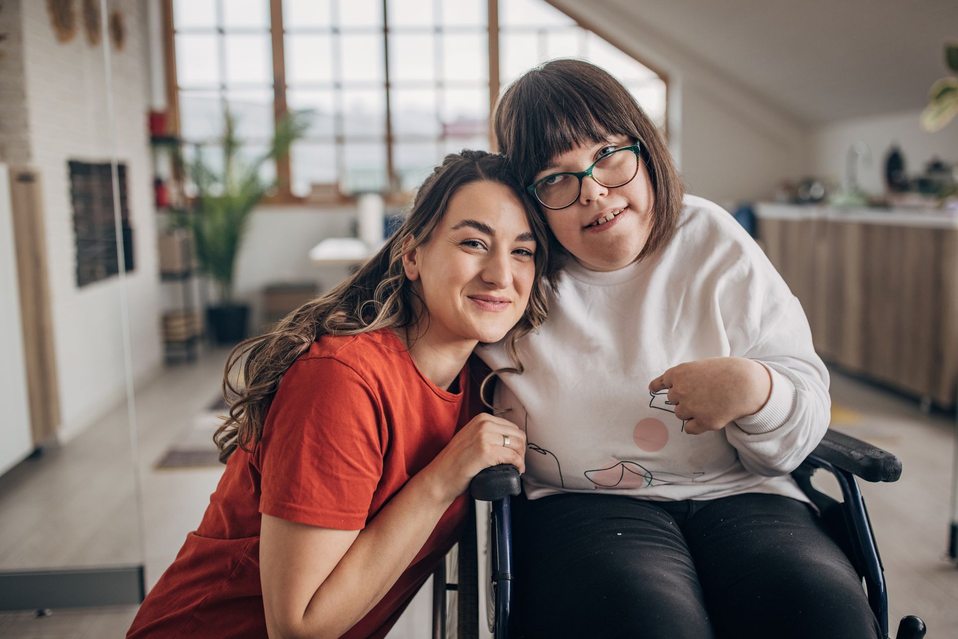 A allied healthcare support worker with a woman in a wheelchair.