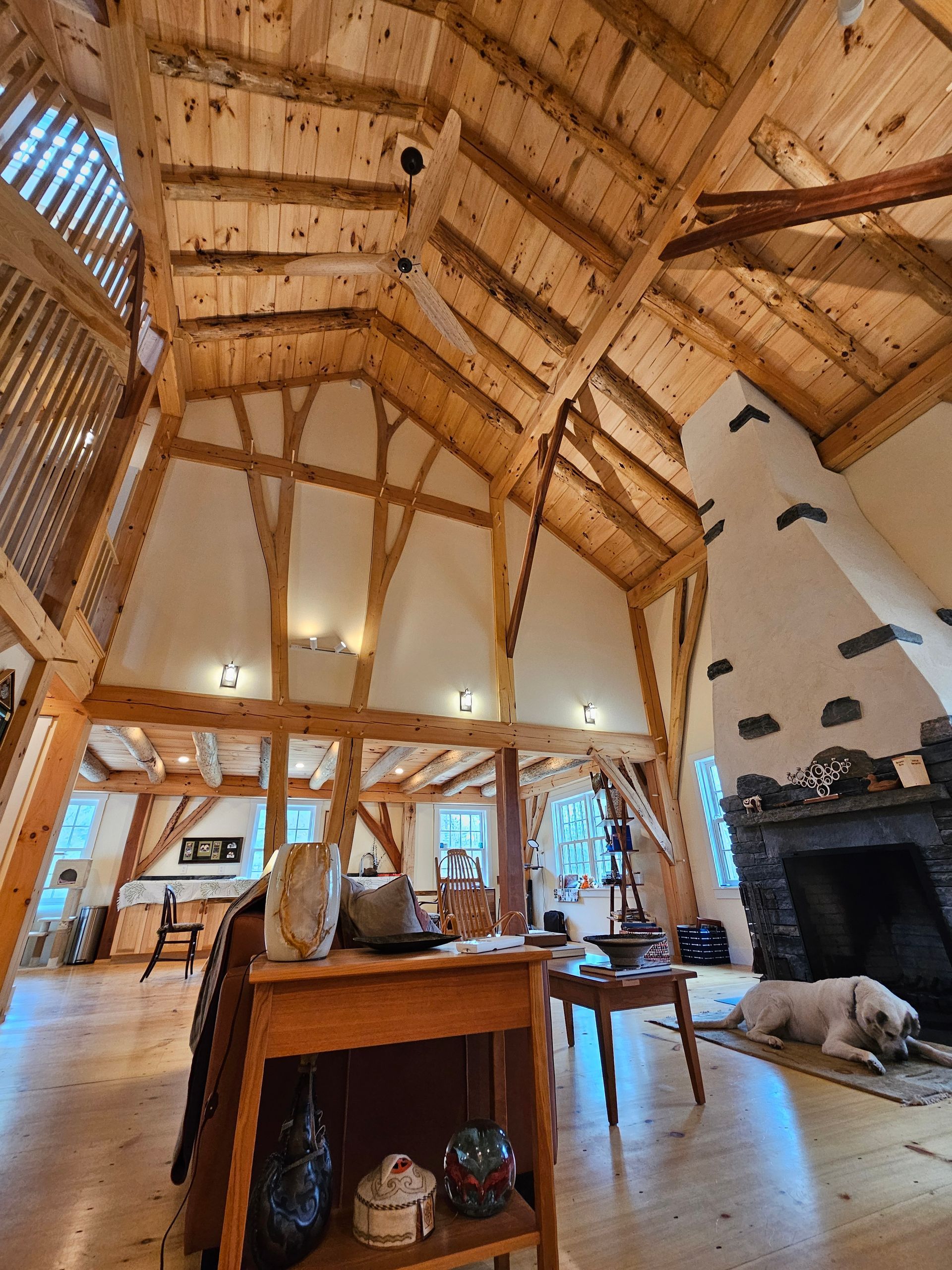 A living room with a wooden ceiling and a fireplace
