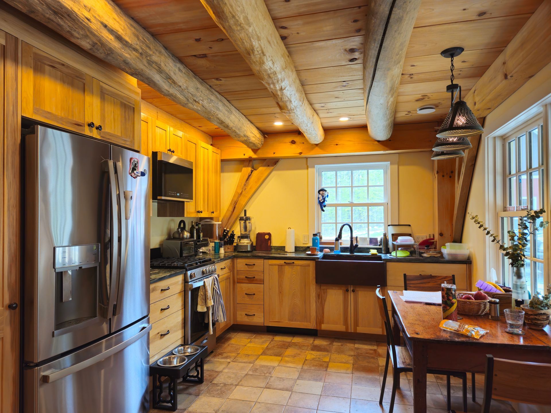 A kitchen with stainless steel appliances and wooden cabinets
