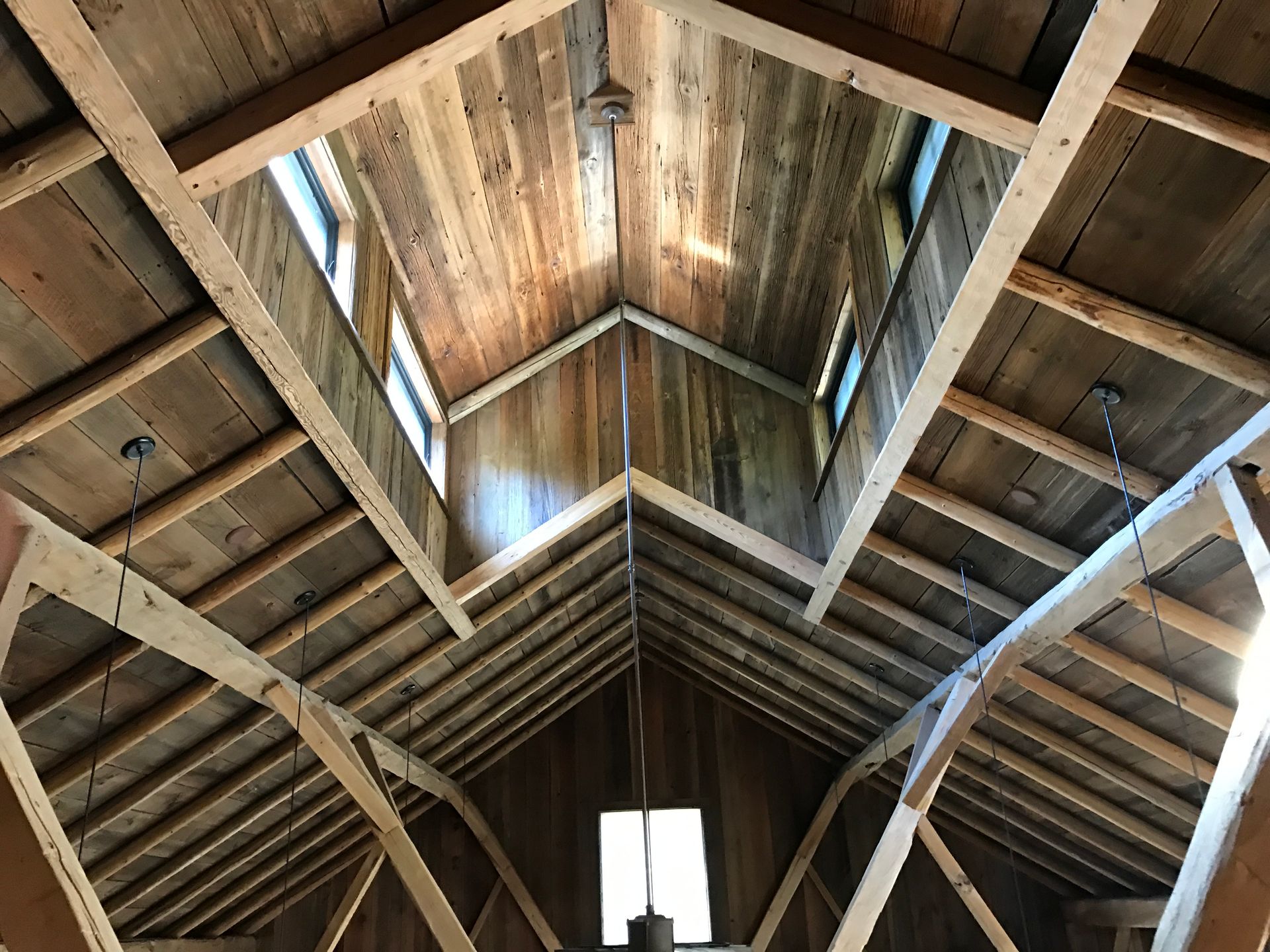 Looking up at the ceiling of a wooden building.