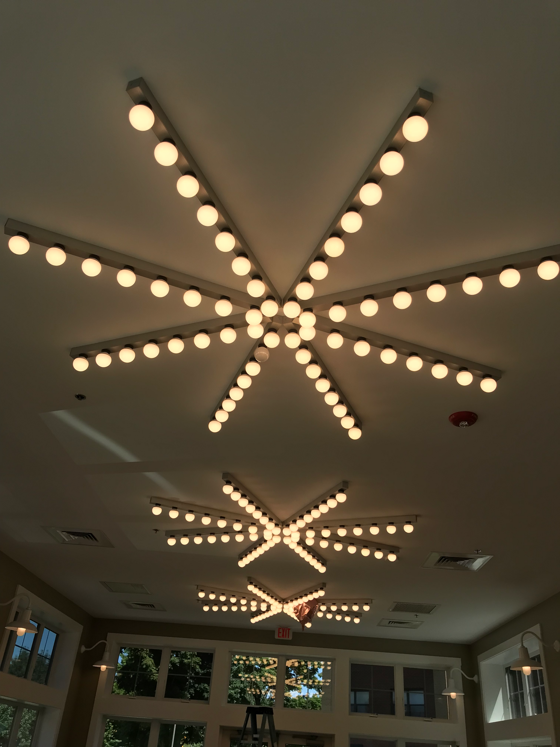 A room with a star shaped light fixture on the ceiling