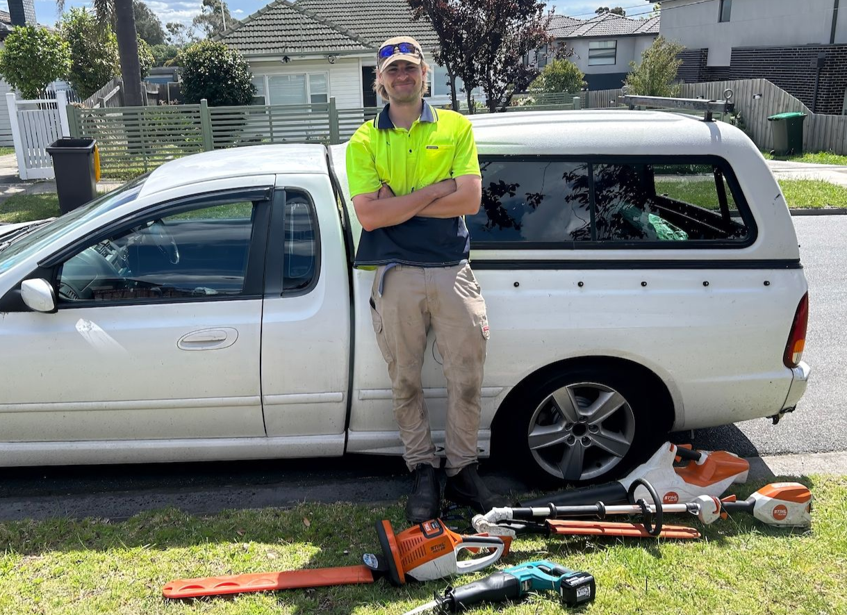 Mowbuddy Aidan standing next to his truck.
