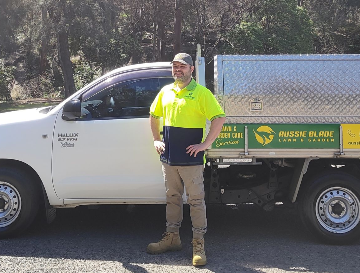 Mowbuddy Phillip standing next to his ute.