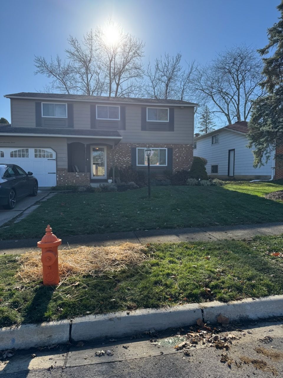 Leaking water pipe spurting water onto a red surface. The pipe is covered in a beige protective wrapping.