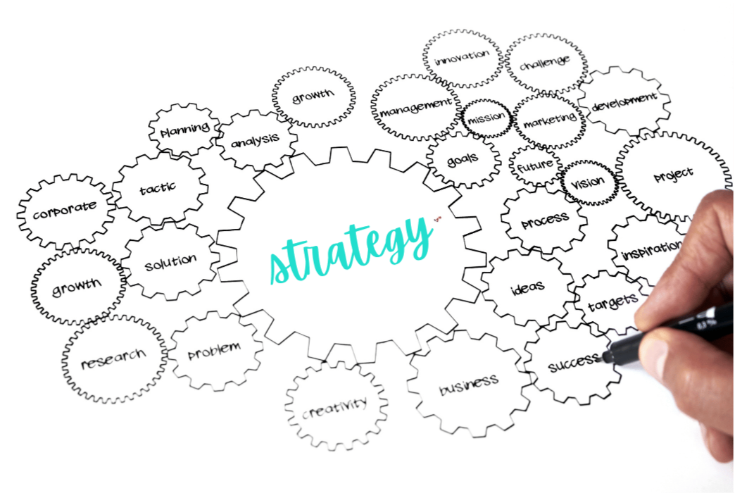 A laptop and a cell phone are sitting next to each other on a white background.