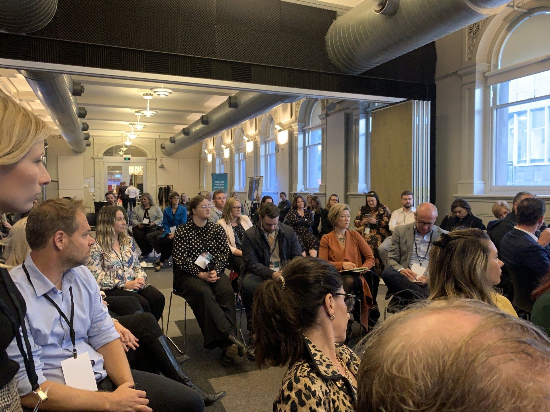 A large group of people are sitting in a room.