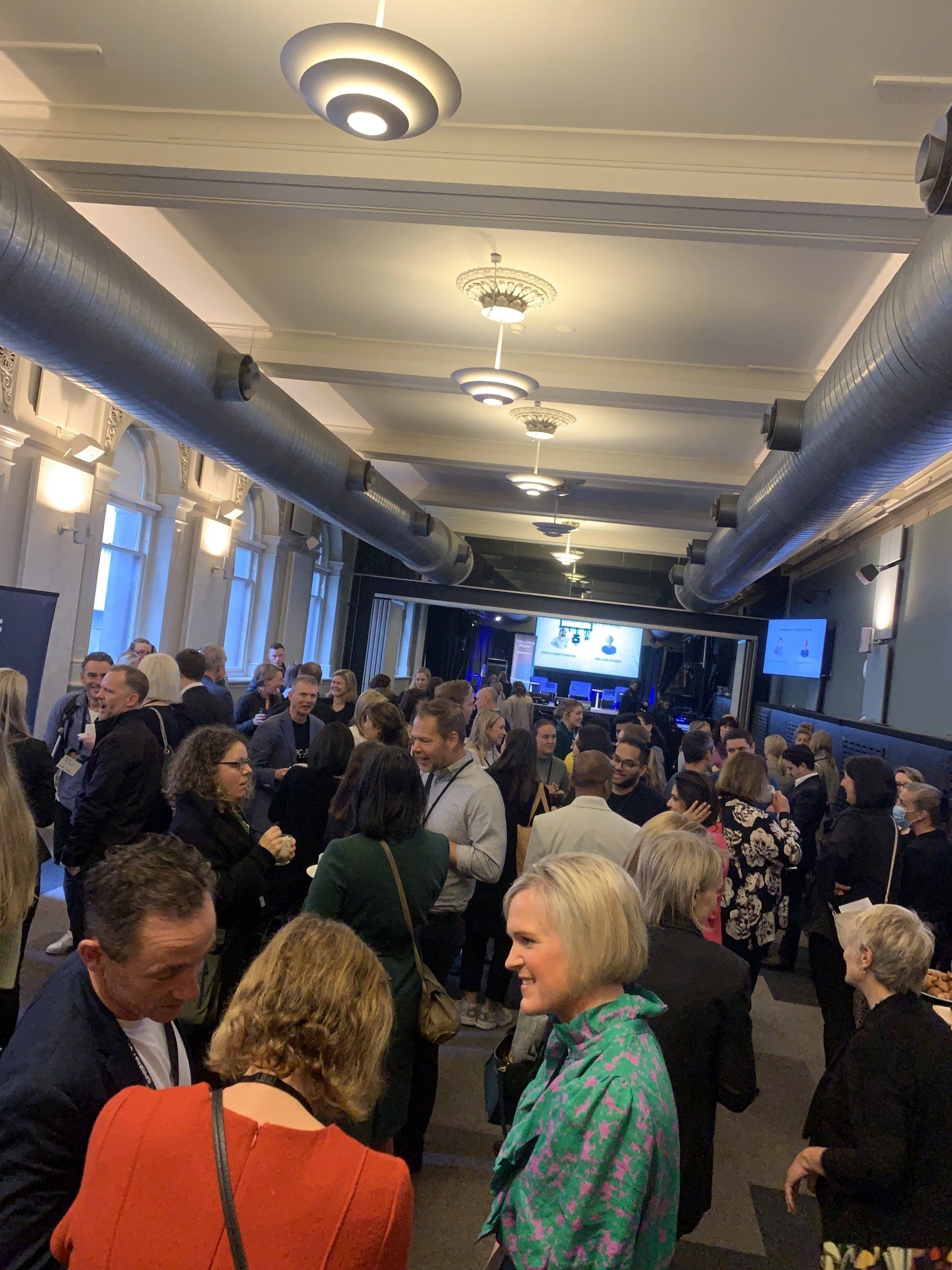 A large group of people are standing in a room.