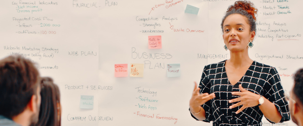 A group of people are sitting around a table in a living room.
