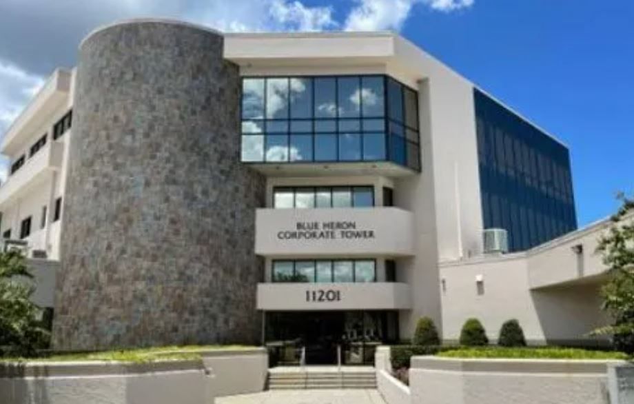 A large white building with the number 1120e on the front