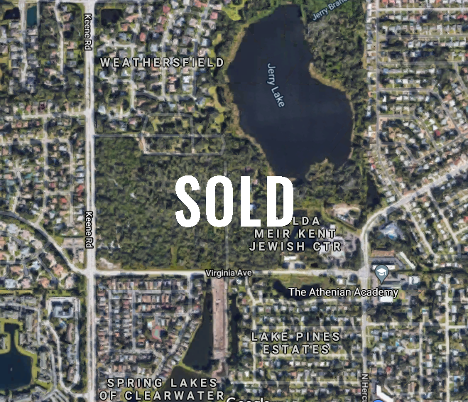 An aerial view of a residential area with the word sold on it