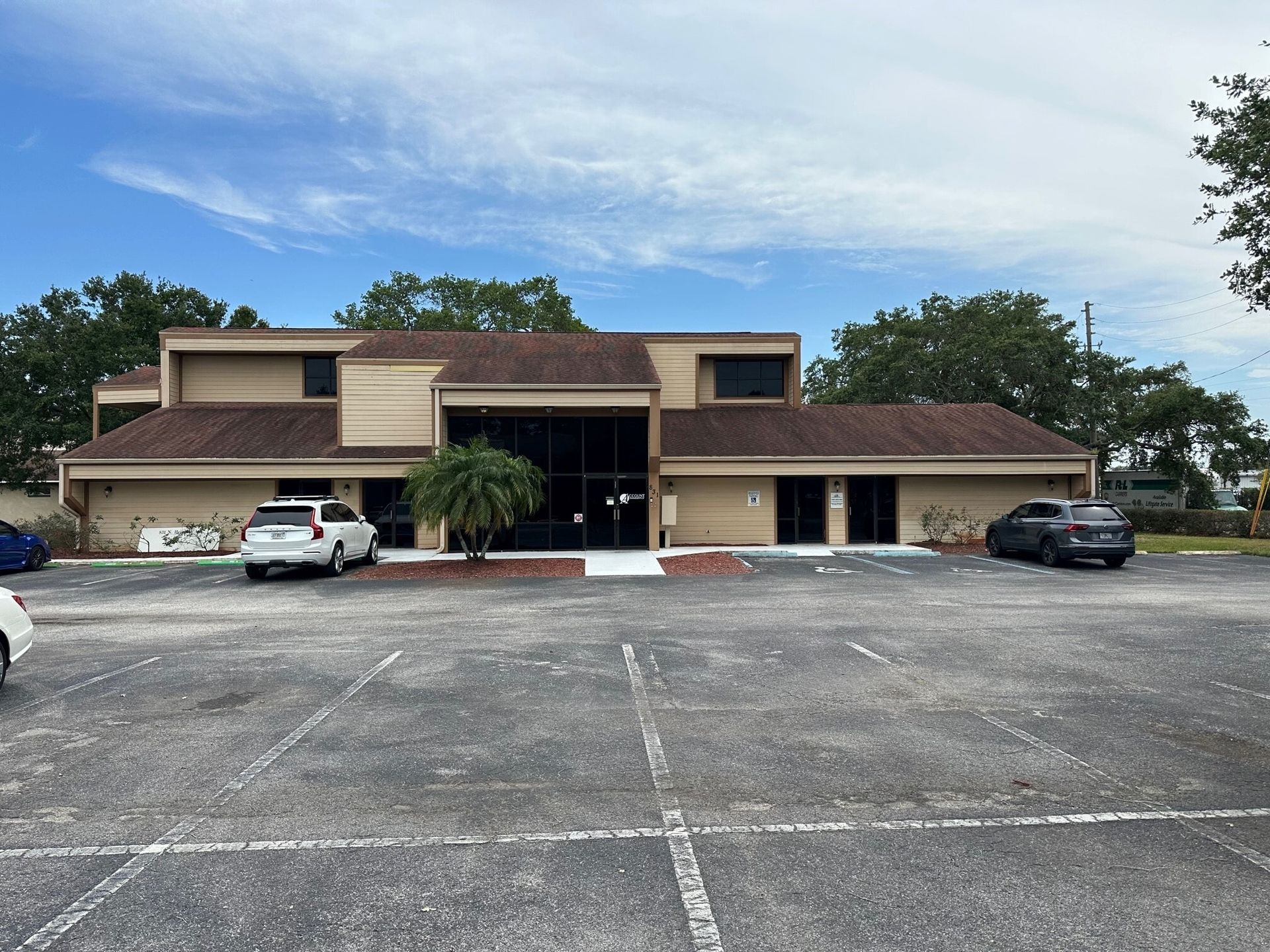 A large building with a parking lot in front of it