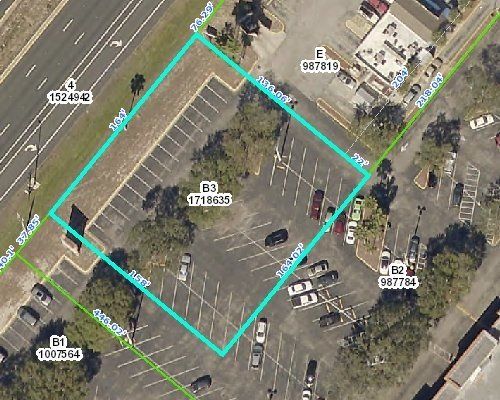 An aerial view of a parking lot with a blue border