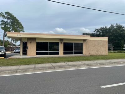 A building with a lot of windows is next to a road