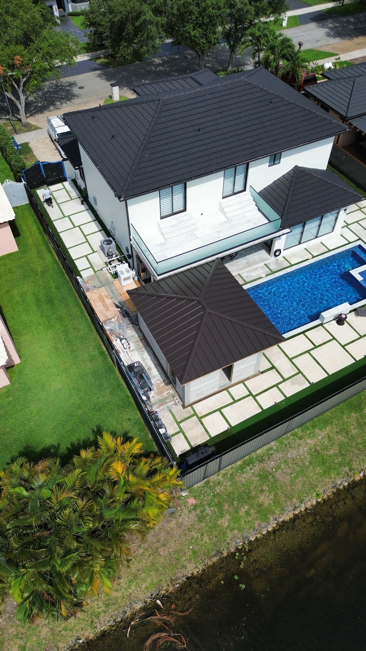 An aerial view of a house with a pool in the backyard.