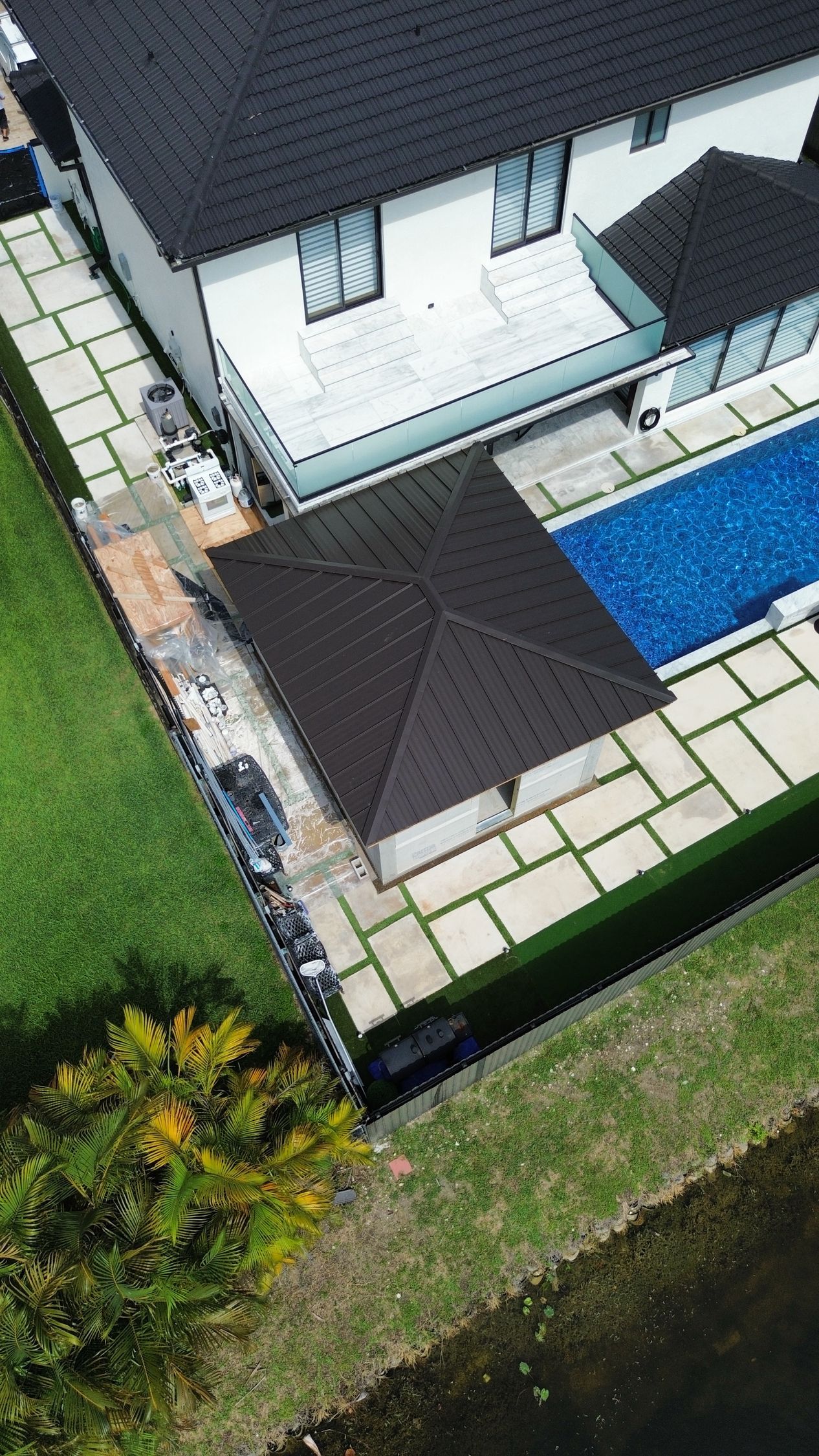 An aerial view of a house with a swimming pool.