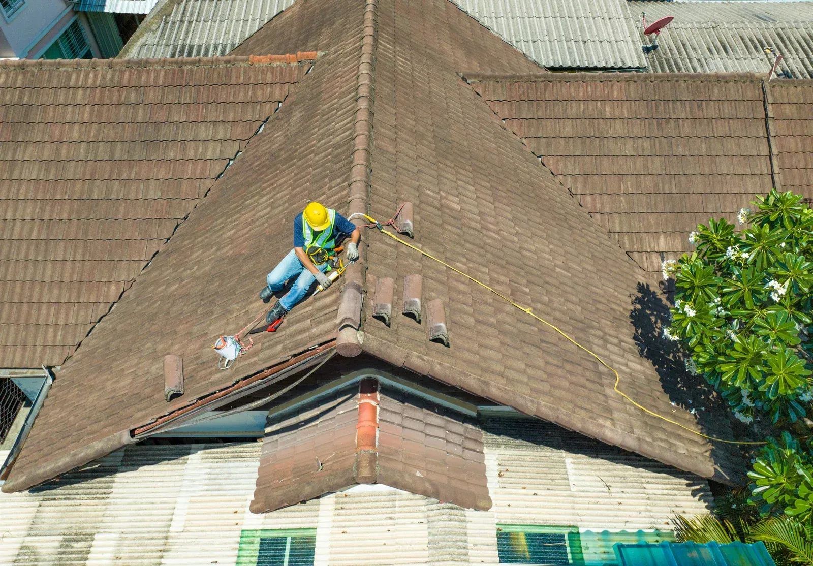 An aerial view of a man sitting on top of a roof.