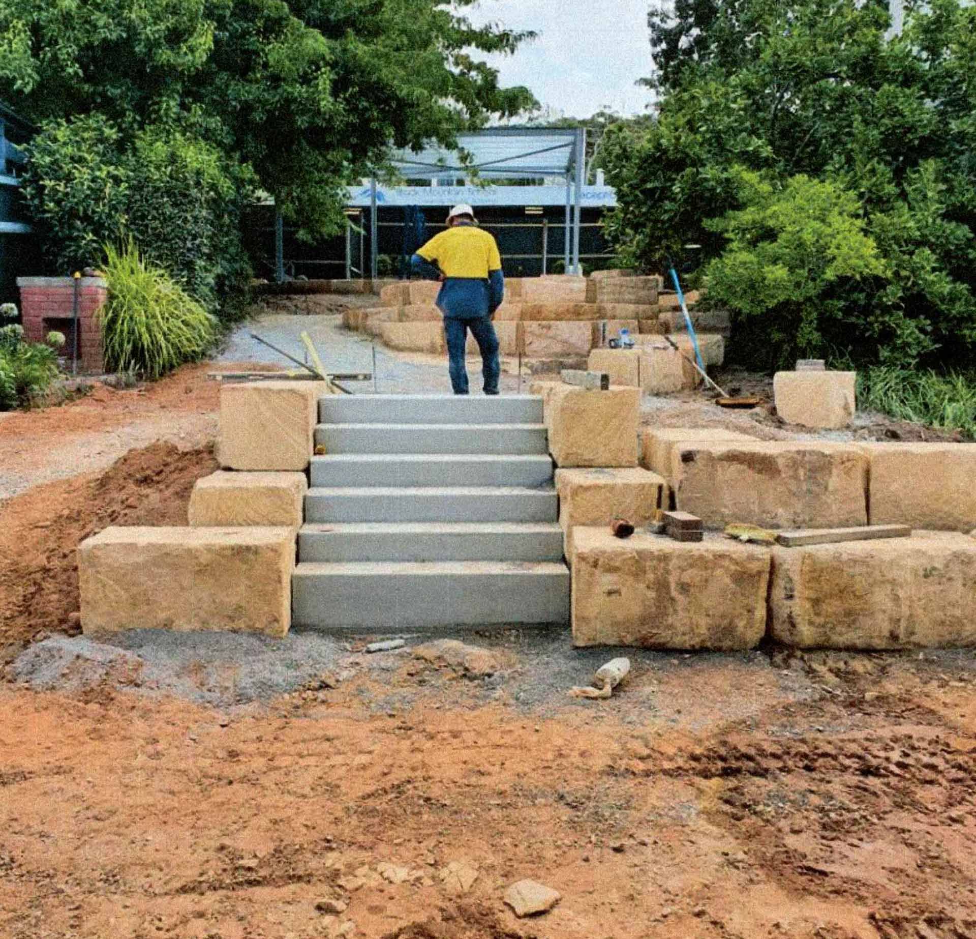 Playground with colorful rubber surfacing and a mural depicting a parrot, balloons, and Parliament House.