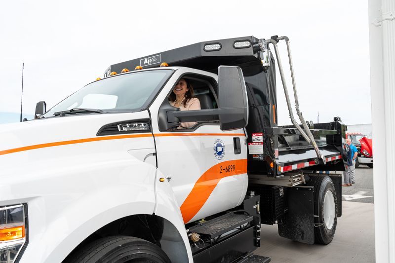 Deputy Commissioner of Connecticut DOT, Karen Kitsis sitting in a new State F750 Ford dump truck