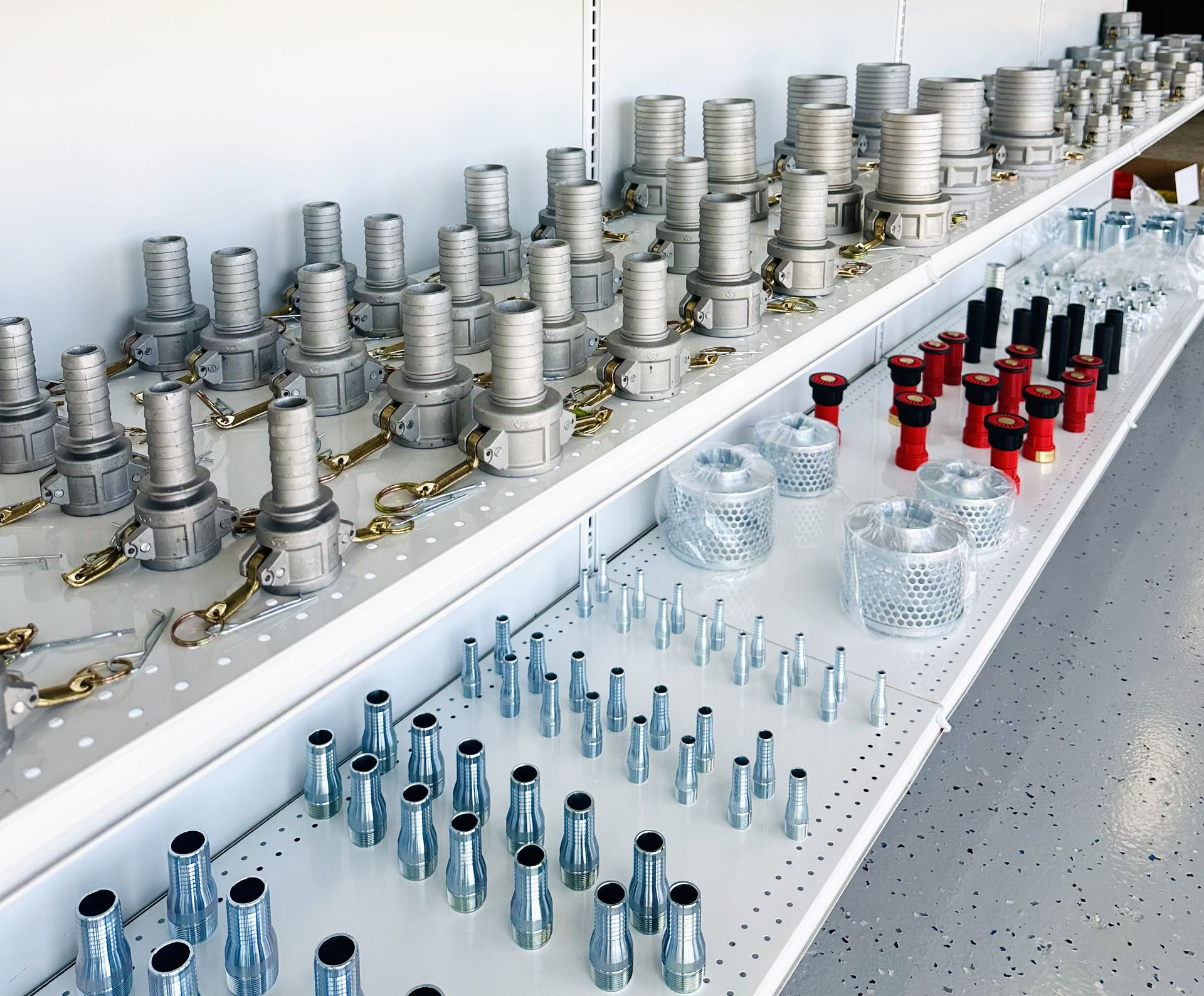 Rows of silver and red lab vials on a white counter, with glass bottles and containers in a clean workspace