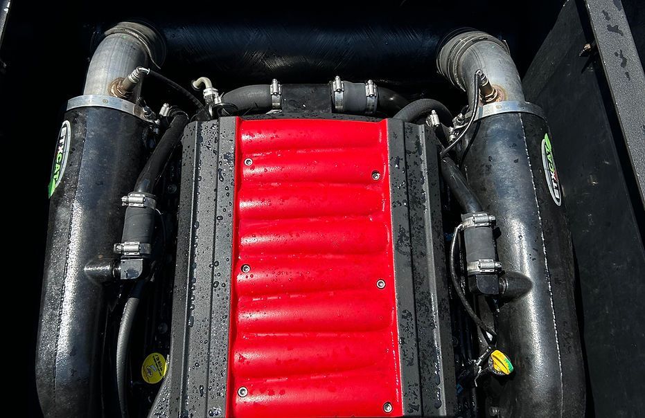 A close up of a red engine on a boat.