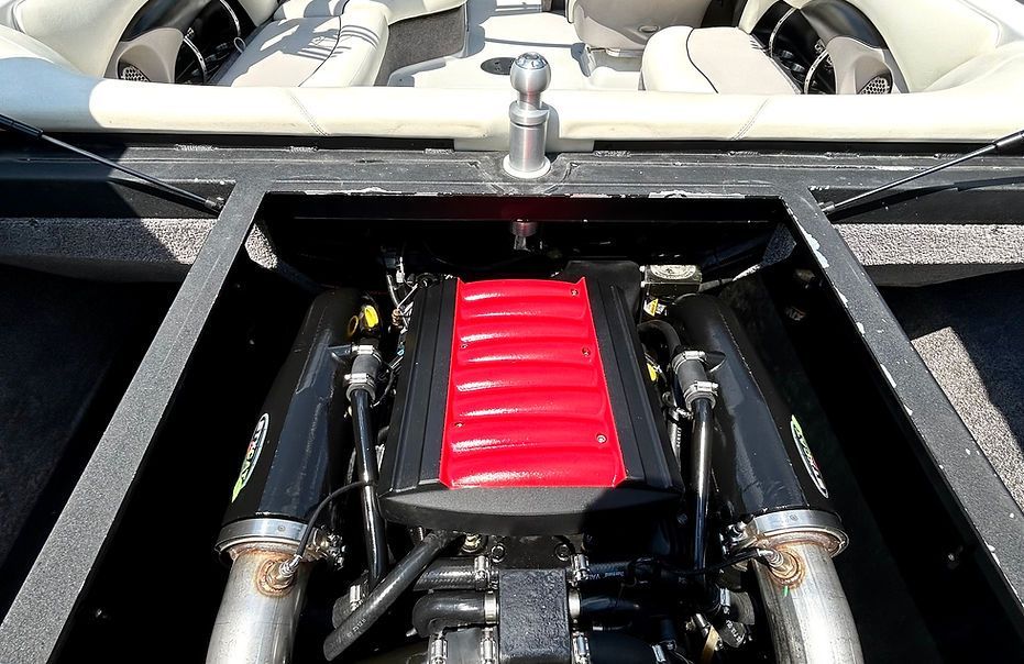 The engine of a boat has a red cover on it