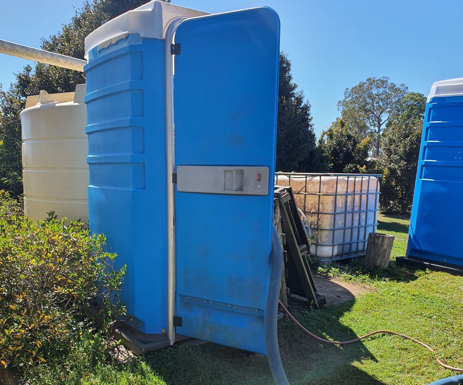 Man Wearing Gloves Lifting a Manhole Cover — Waste Disposal in Maryborough, QLD
