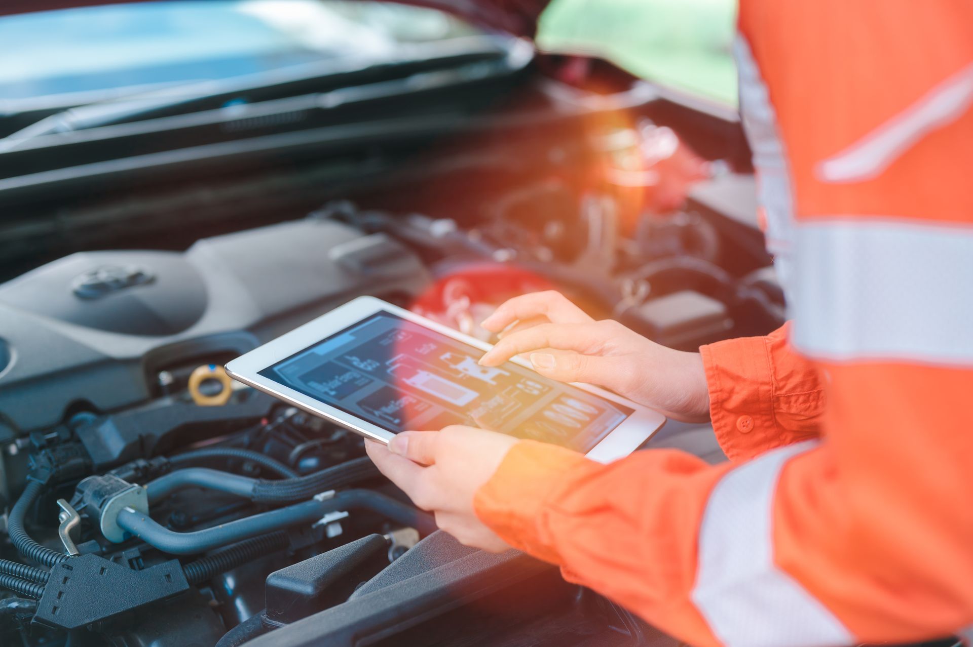 Hand of a mechanic holding the tablet for the vehicle maintenance checklist