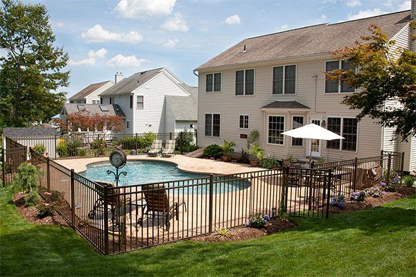 Lush Backyard Pool and Patio — Centerville, IN — OLER Fence and Construction